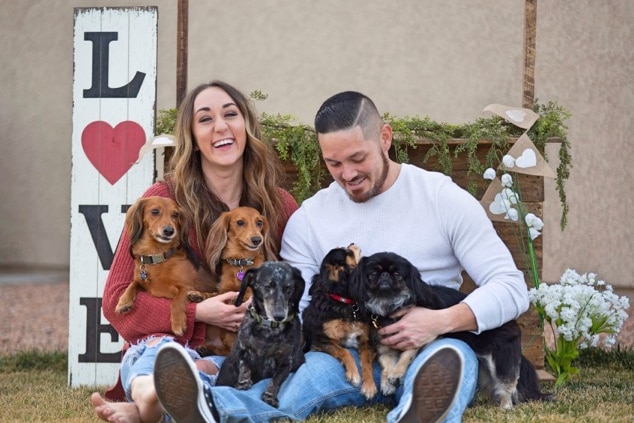 A man and woman and their five dogs