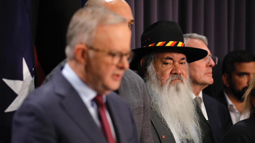 Pat Dodson listens as he stands behind Anthony Albanese 
