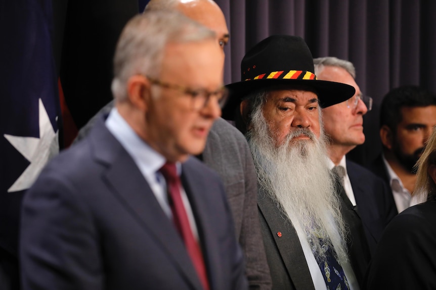 Pat Dodson listens as he stands behind Anthony Albanese 