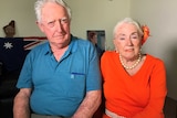 Ron McLean and his wife Marye Louise Daniels pose for a photo sitting down indoors.