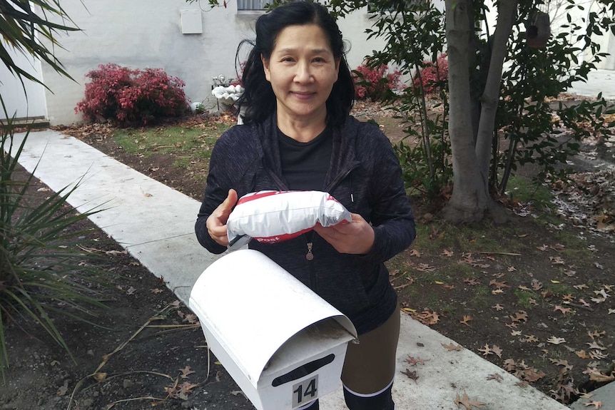 Sunida Ratanakosol checks her mail.