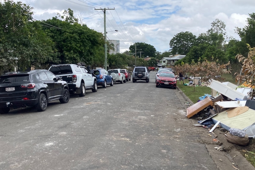 Rubbish from flooded houses lines a suburban street