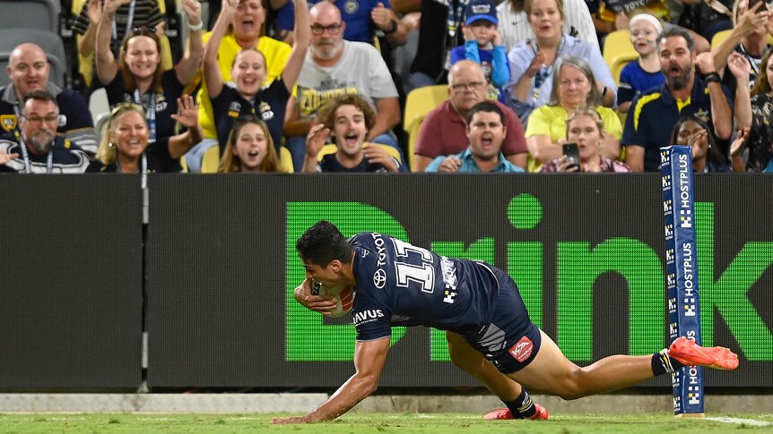 A man goes in to score a try during a rugby league match