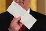 A closeup of a closed letter with the words Mr President written on it.