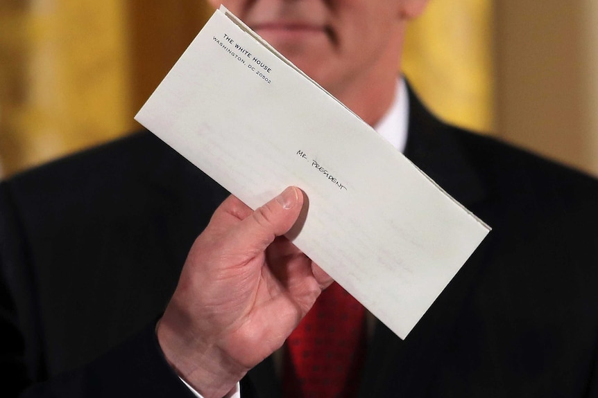 A closeup of a closed letter with the words Mr President written on it.