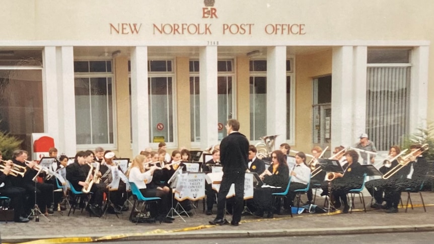 brass band perform on street outside historic "New Norfolk Post Office" building