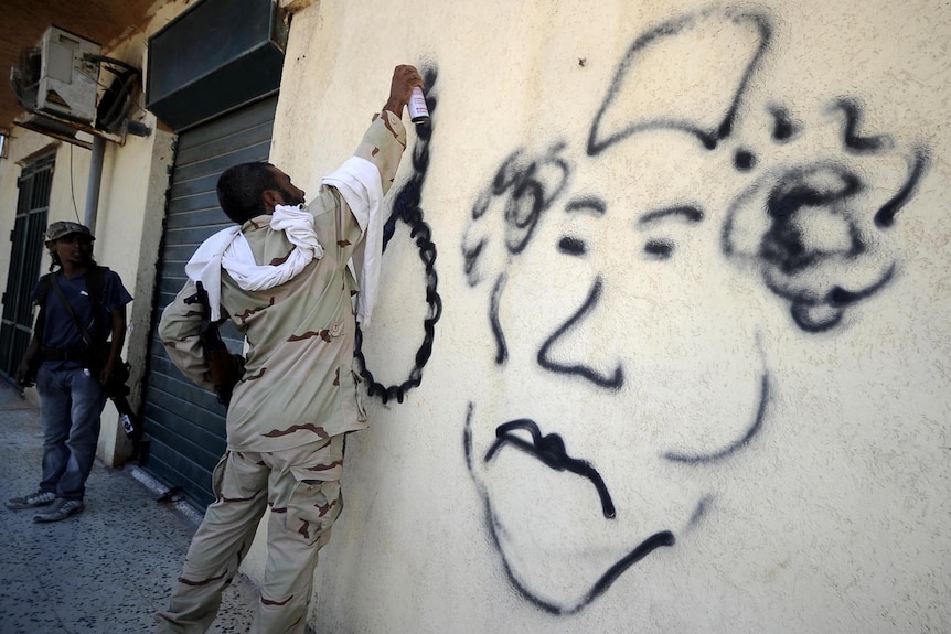 Moamar Gaddafi graffiti on a wall in Libya