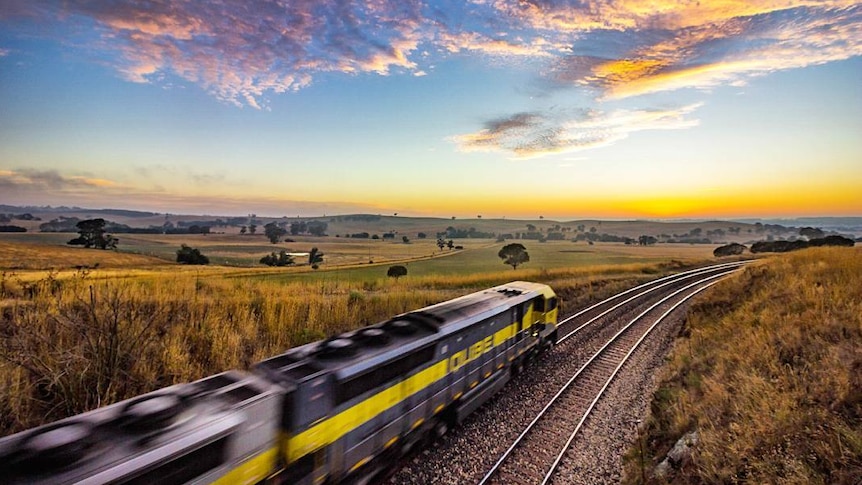 Train in the countryside at sunset