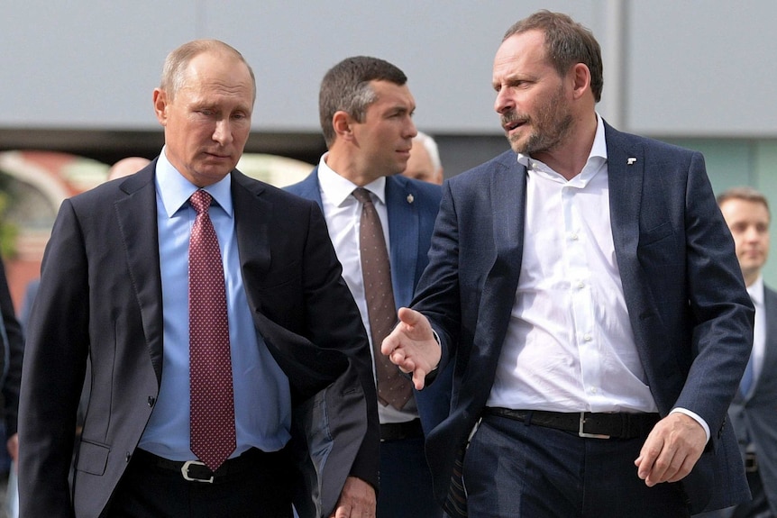 Vladimir Putin, left, walks next to Yandex CEO Arkady Volozh, right.