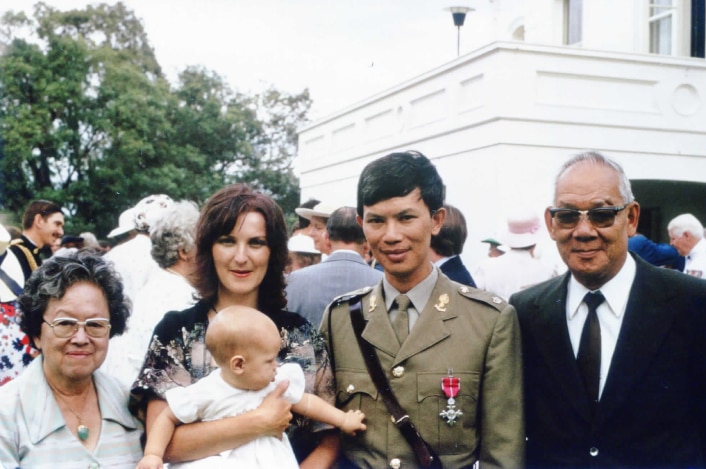 Darryl Low Choy poses for a photo with his parents, wife and child at Government House.