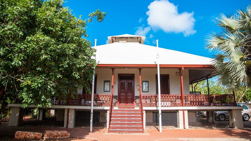 A modest country courthouse, raised off the ground in the fashion of a Queenslander house.