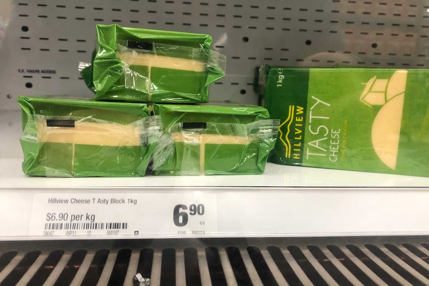 Cheap blocks of cheese for sale on the shelves at Woolworths.