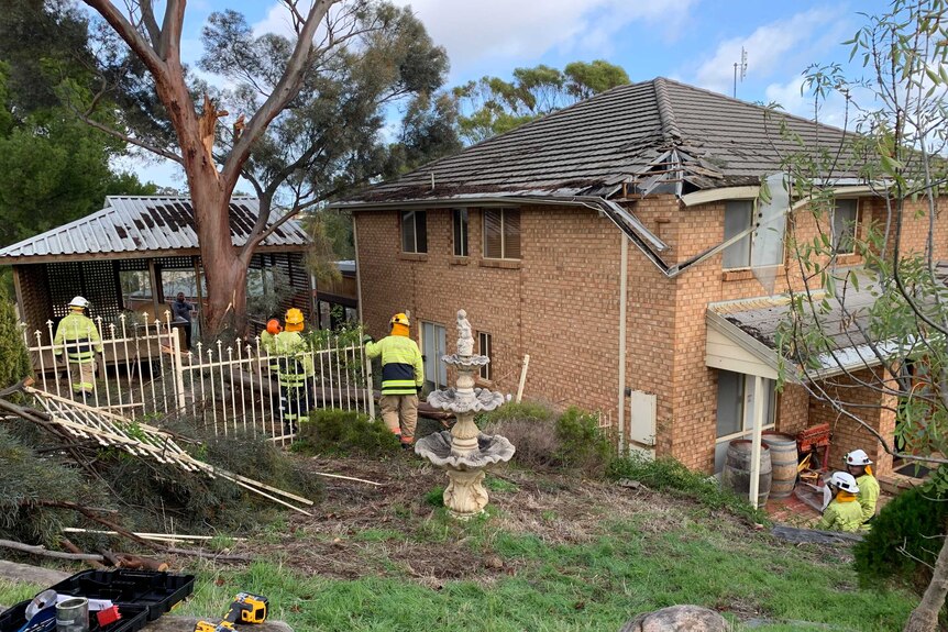 A two-storey house in Adelaide with damage to its roof and garden