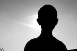 Silhouette of young boy in black and white