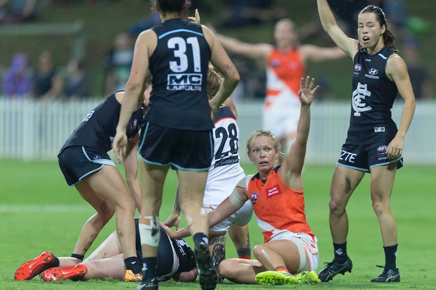 Carlton's Brianna Davey (on the ground) is injured against GWS in AFLW round two at Drummoyne Oval.