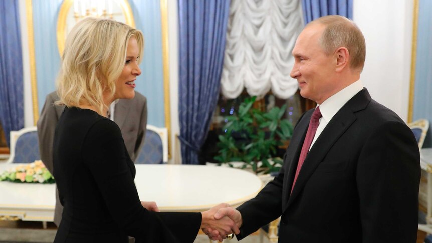 American broadcaster Megyn Kelly shakes hands with Russian President Vladimir Putin inside the Kremlin in Moscow.