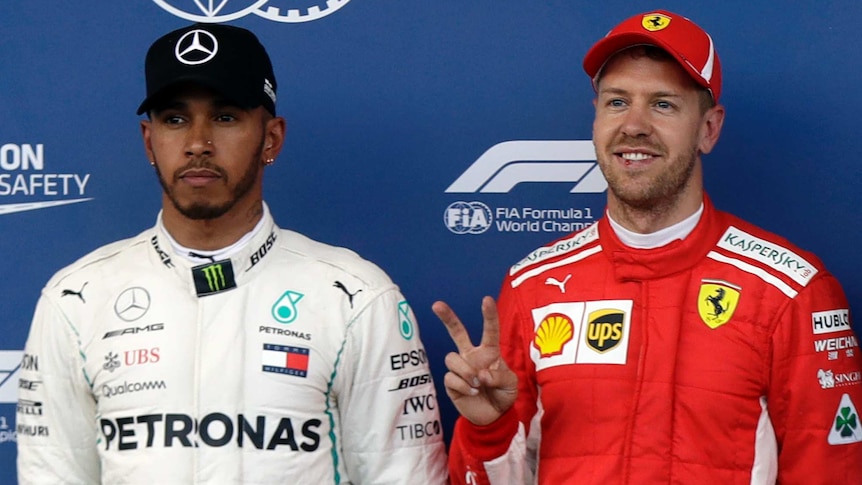 Lewis Hamilton (L) and Sebastian Vettel pose for photos after qualifying for the Azerbaijan F1 GP.