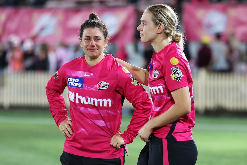 Nicole Bolton fights back tears as she is consoled by her teammate Maitlan Brown