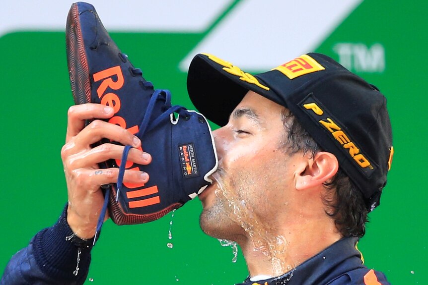 Red Bull's Daniel Ricciardo drinks from a shoe.