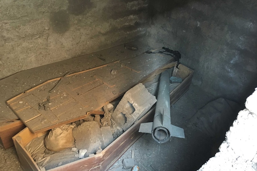 An IS rocket lodged in a coffin in a local family crypt