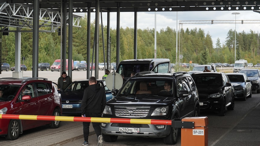 Cars queue at crossing point in Finland and people drive from Russia.