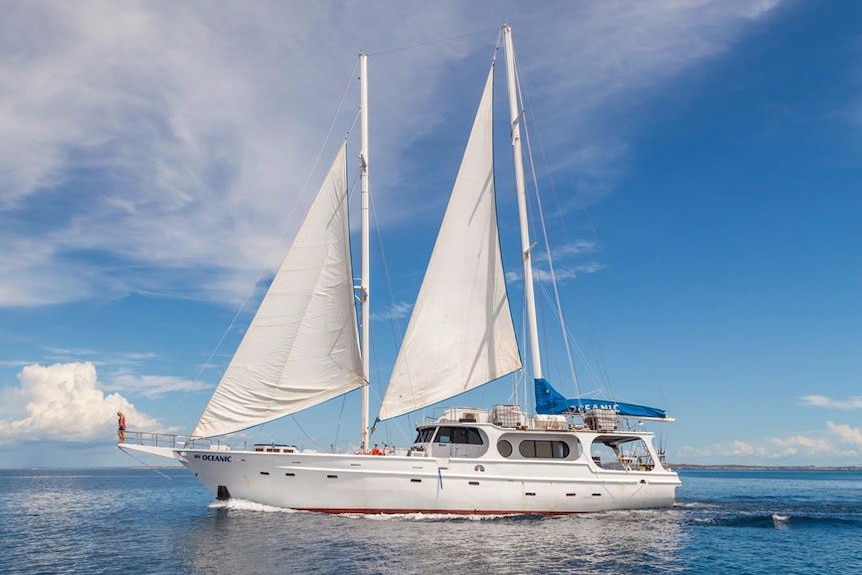 A yacht with two sails on a blue ocean