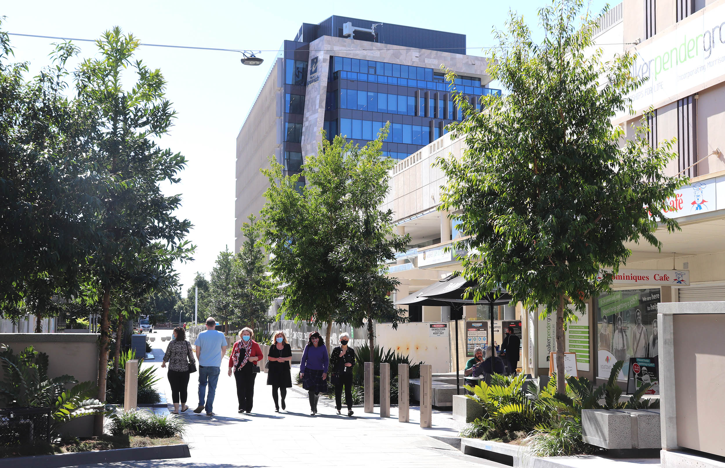 Five people walking through the Ipswich mall