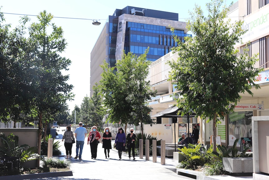 Five people walking through the Ipswich mall