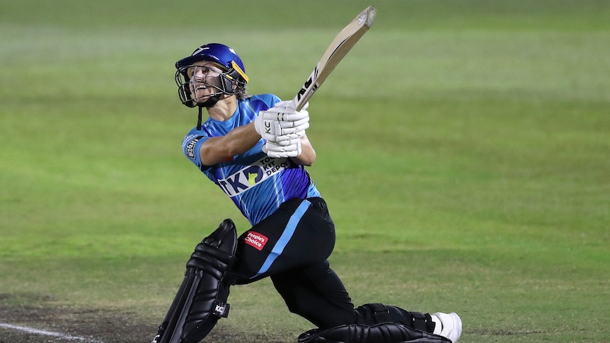 An Adelaide Strikers WBBL player hits out to the leg side during a match against the Brisbane Heat.