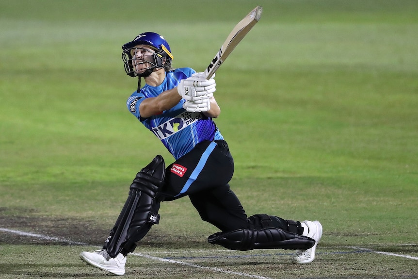 An Adelaide Strikers WBBL player hits out to the leg side during a match against the Brisbane Heat.