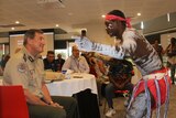 The Commissioner of Correctional Services Mark Payne watches a performing prison inmate