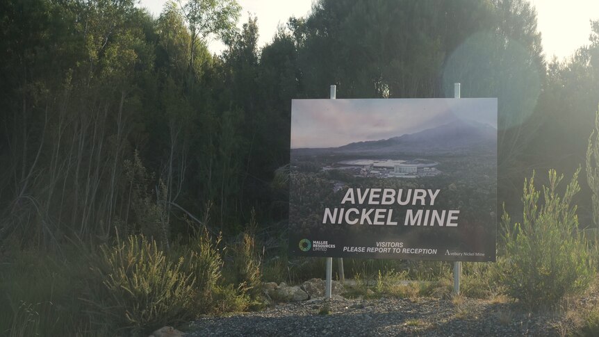 A sign that says "Avebury Nickel Mine" near some trees