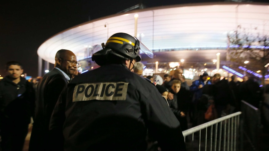 Police control crowds leaving the Stade de France