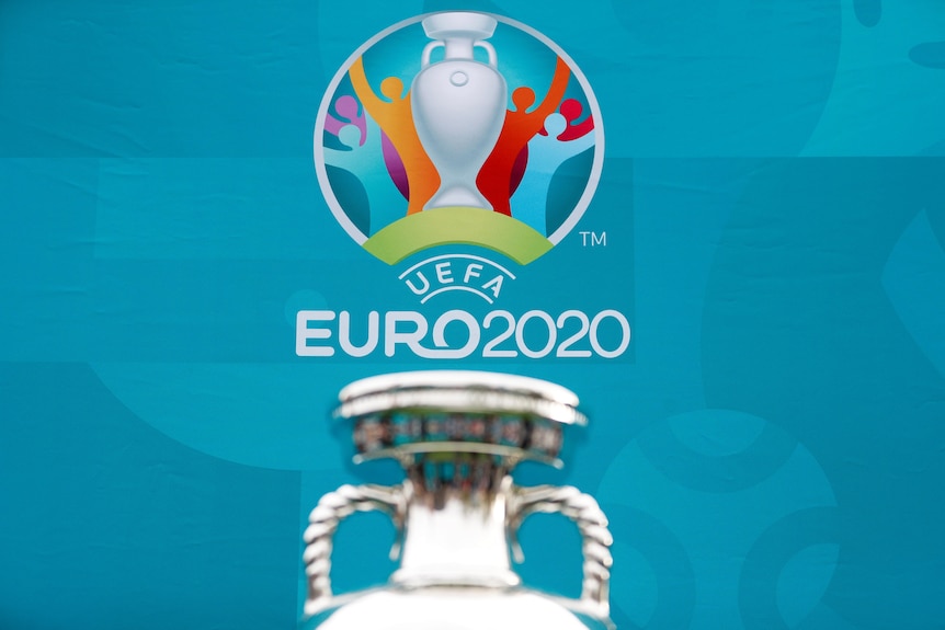 A logo of Euro 2020 is shown with the top of a silver trophy in the foreground