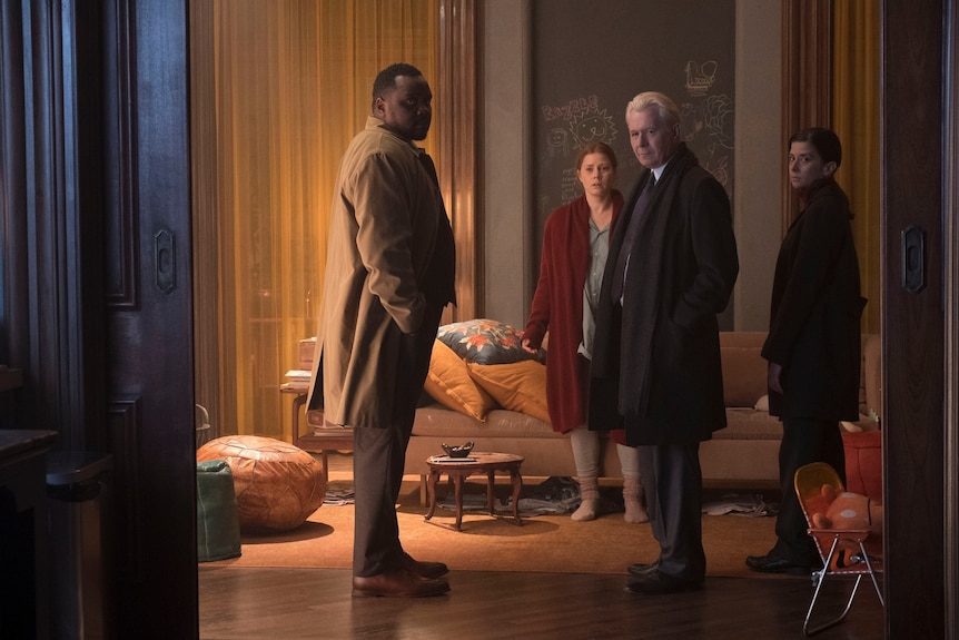 Film still of Brian Tyree Henry, Amy Adams, Gary Oldman and Jeanine Serralles facing the camera in The Woman in the Window