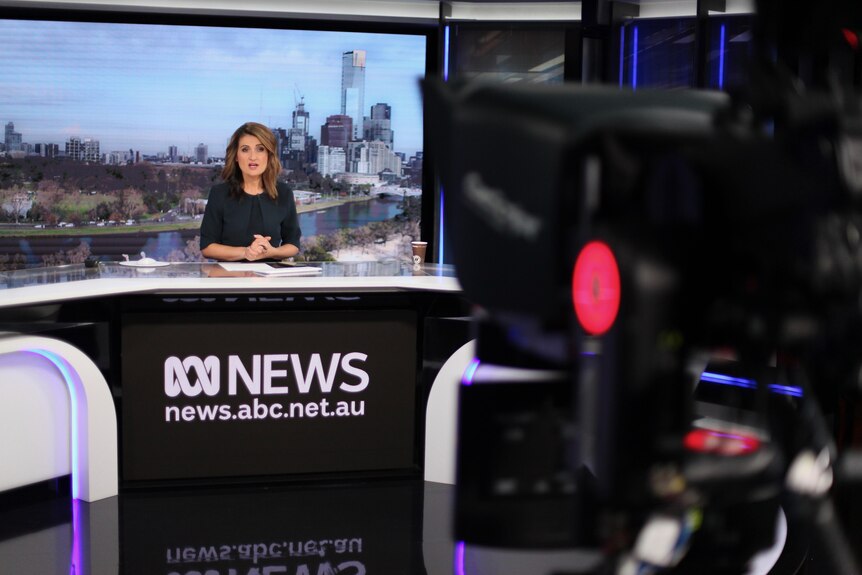 A camera can be seen in the foreground as Patricia Karvelas sits at the ABC News desk