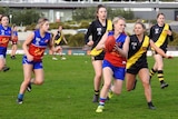 An action shot of women playing football