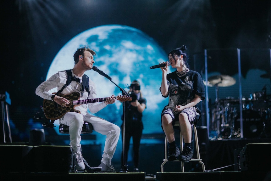 A scene from the documentary  Billie Eilish: The World's a Little Blurry with Billie and her brother Finneas performing on stage