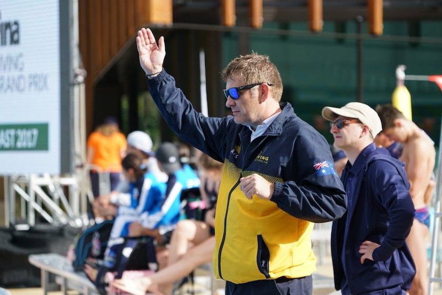 Adrian Hinchcliffe waves his hand in training.