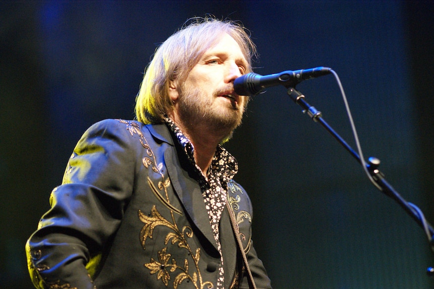 Tom Petty looks down on the crowd as he sings during a show.