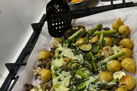Potato, asparagus and cheese line an oven tray.