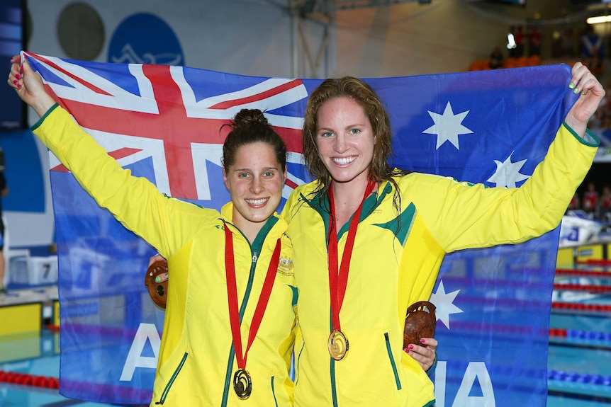 Emily Seebohm and Belinda Hocking show off their medals
