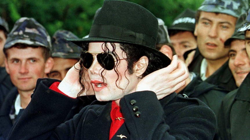 Michael Jackson adjusts his hat upon arrival to Bucharest in September 1996.