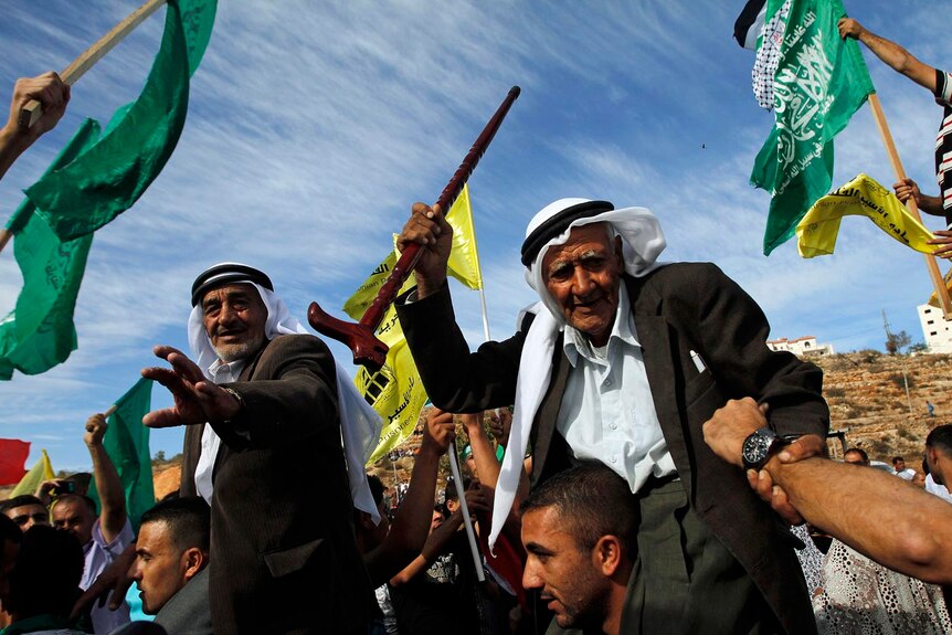 Palestinians at Beituniya checkpoint near the West Bank city of Ramallah celebrate the release of prisoners.