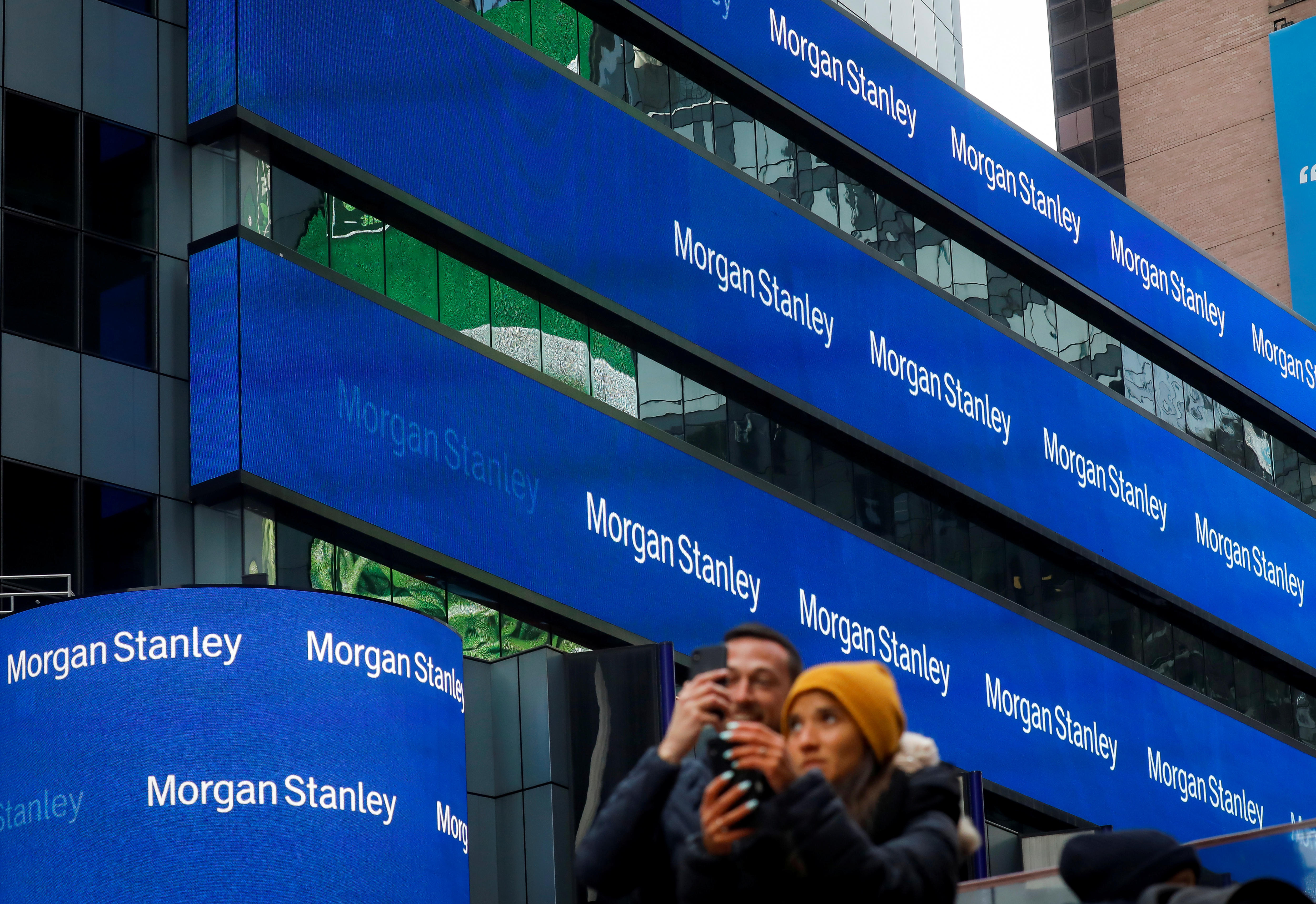 A series of billboards attached to a large building, reading 'Morgan Stanley'.