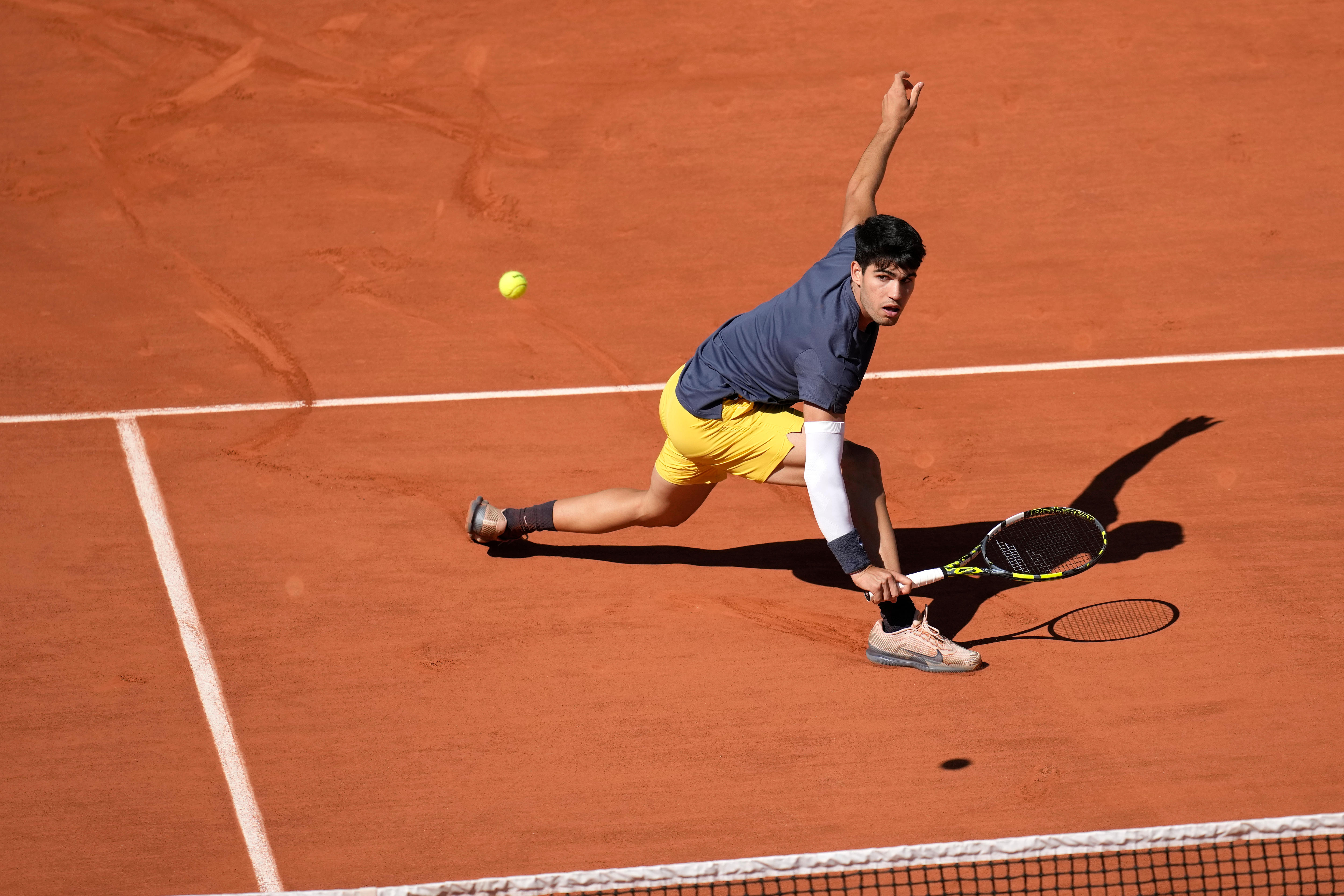 Carlos Alcaraz plays a shot