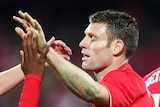 Opening score ... James Milner (R) of Liverpool celebrates with Jordon Ibe after scoring a goal for Liverpool