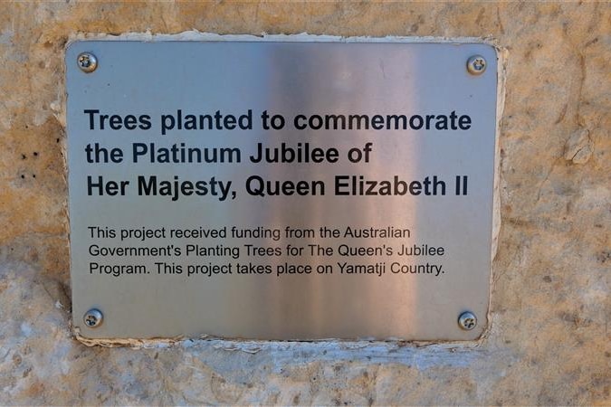A plaque reading "Trees planted to commemorate the Platinum Jubilee of Her Majesty, Queen Elizabeth II". 