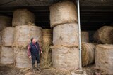 Dairy farmer Michael Perkins with bales of donated hay