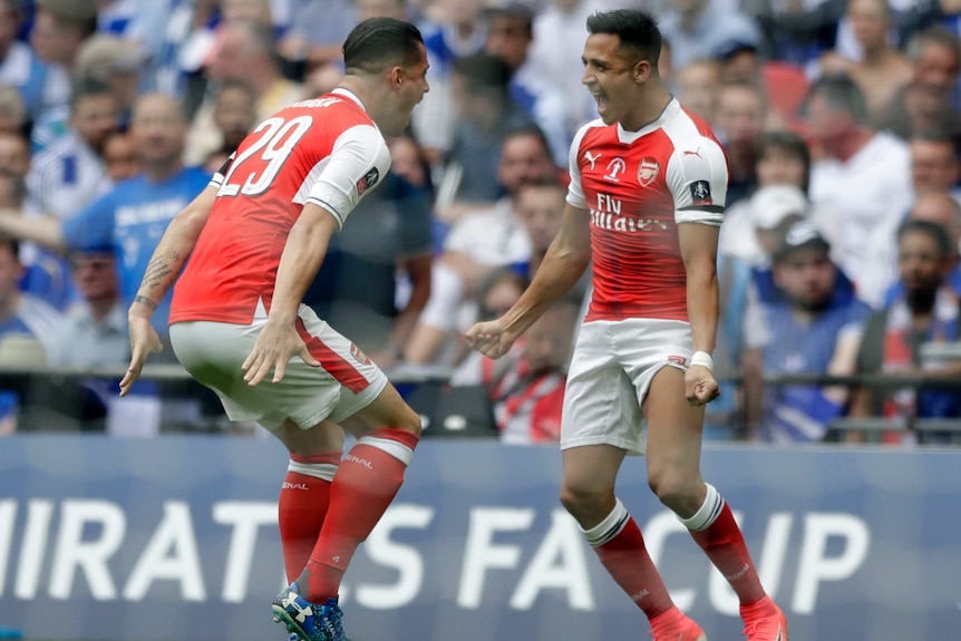 Alexis Sanchez and Granit Xhaka celebrate Arsenal's opener.